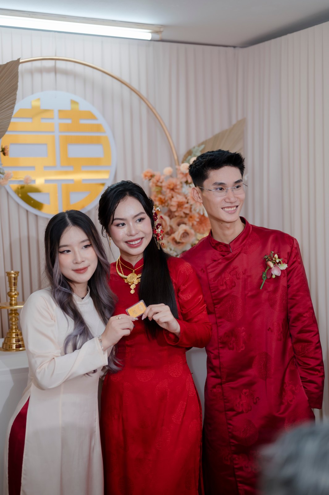 Cô dâu chú rể áo dài đỏ bên gia đình trong nghi lễ ăn hỏi